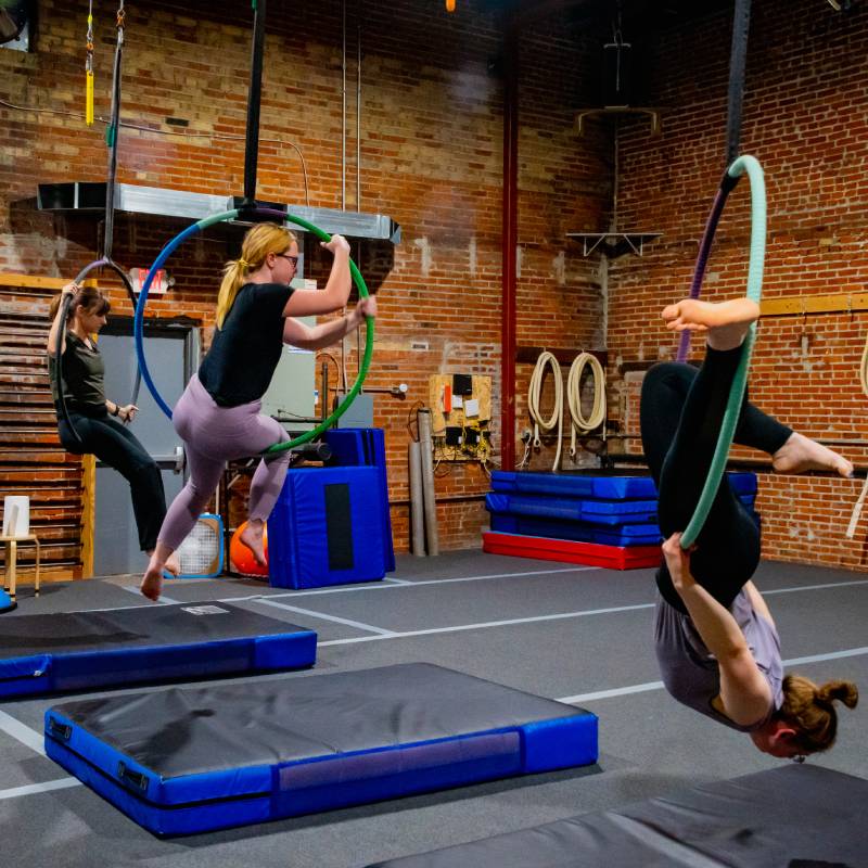 Three students doing hoop